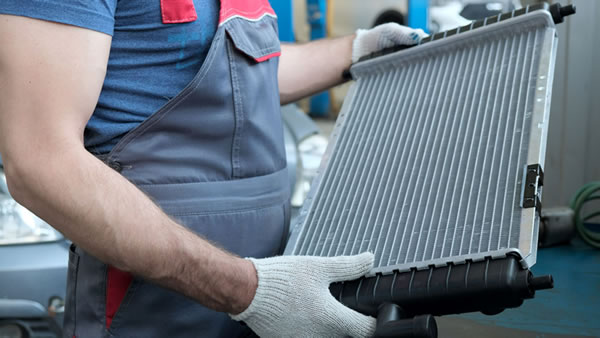 photo of man holding a radiator